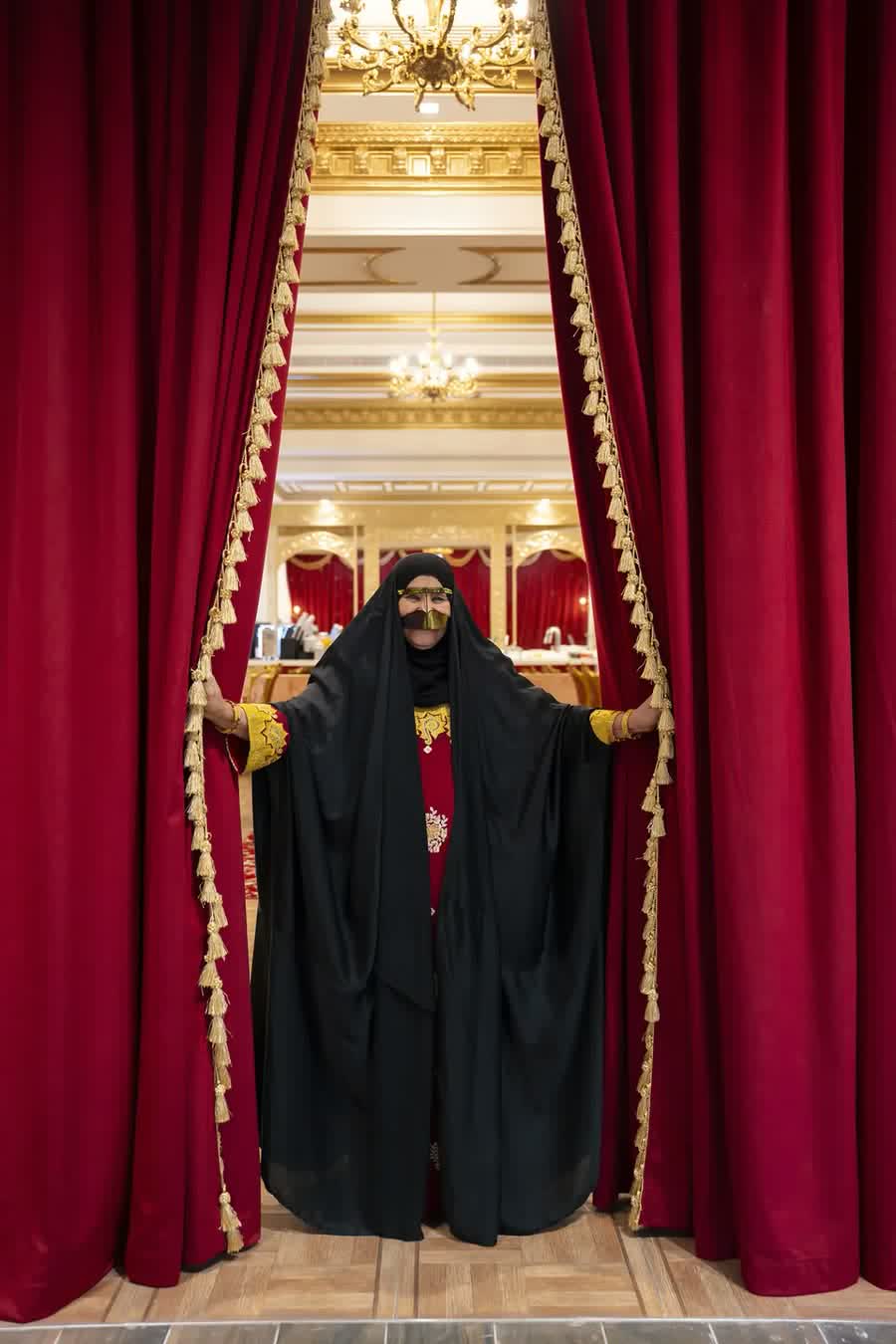 The entrance to Amina framed by deep red curtains