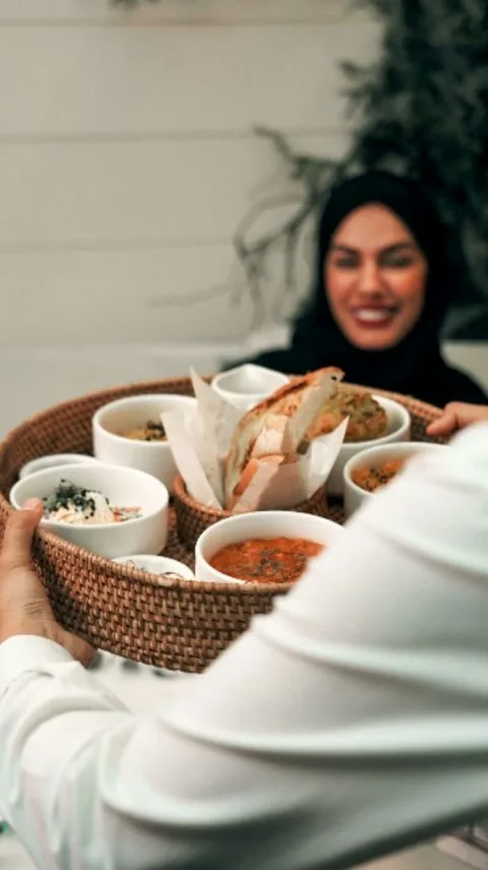 Chef Mariam Almansoori with baskets of fresh bread