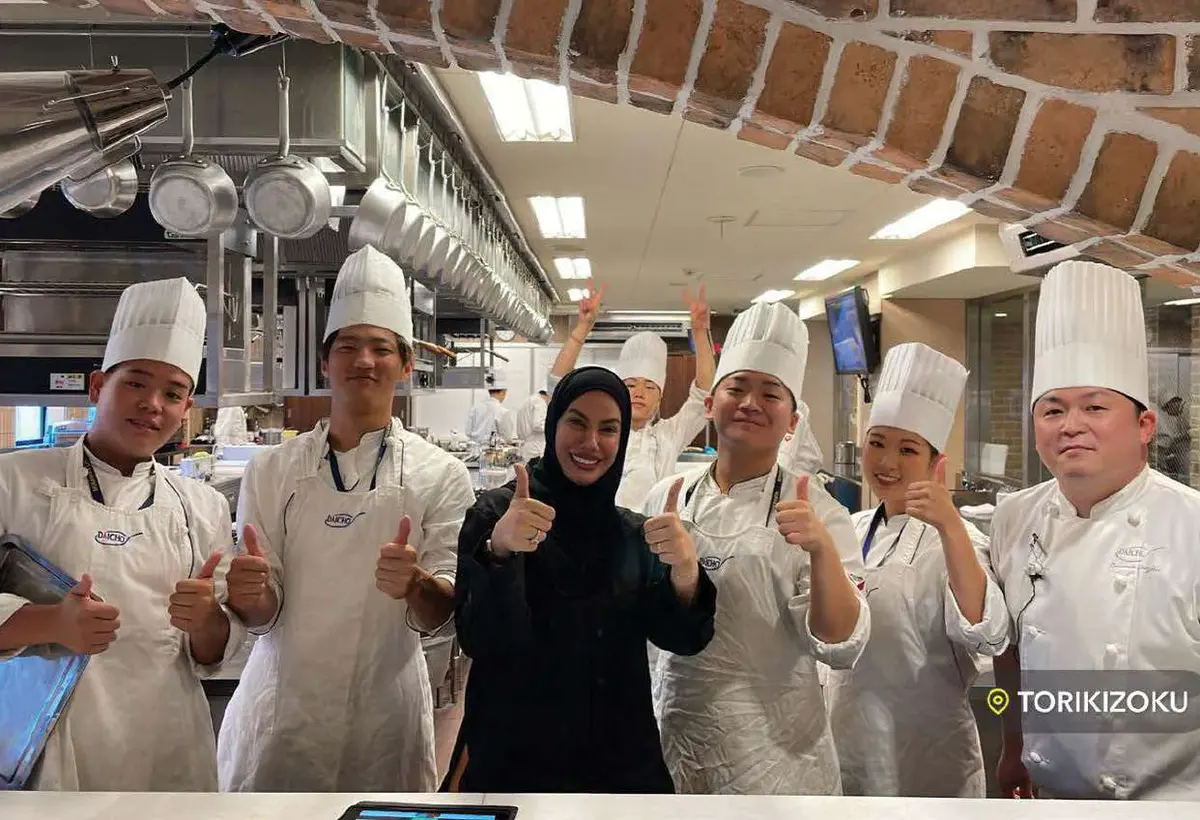 The kitchen team gathered around Chef Mariam