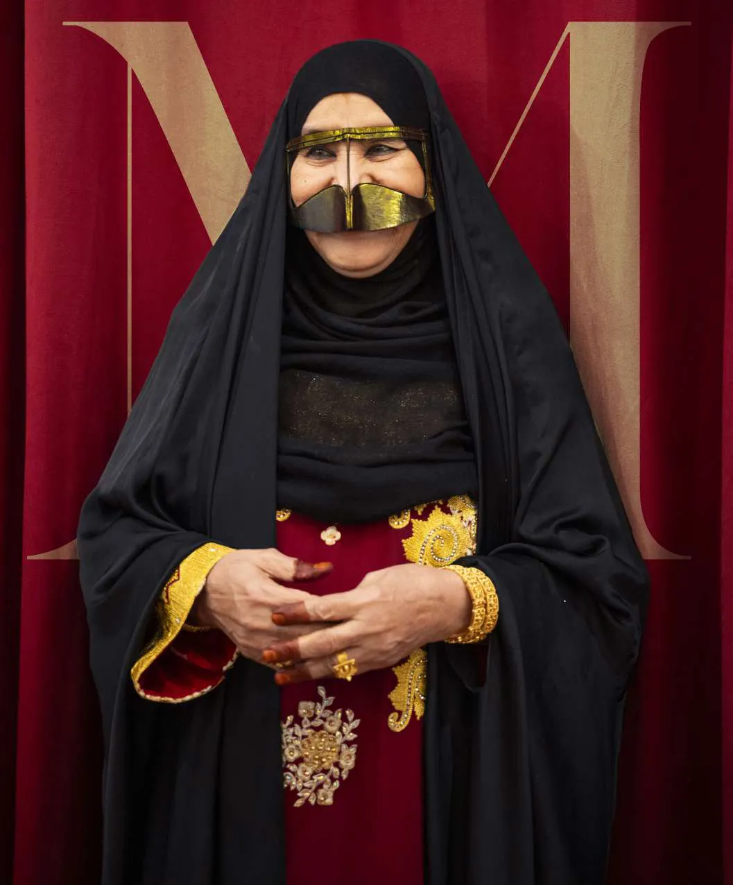 Amina in red and gold at the curtain