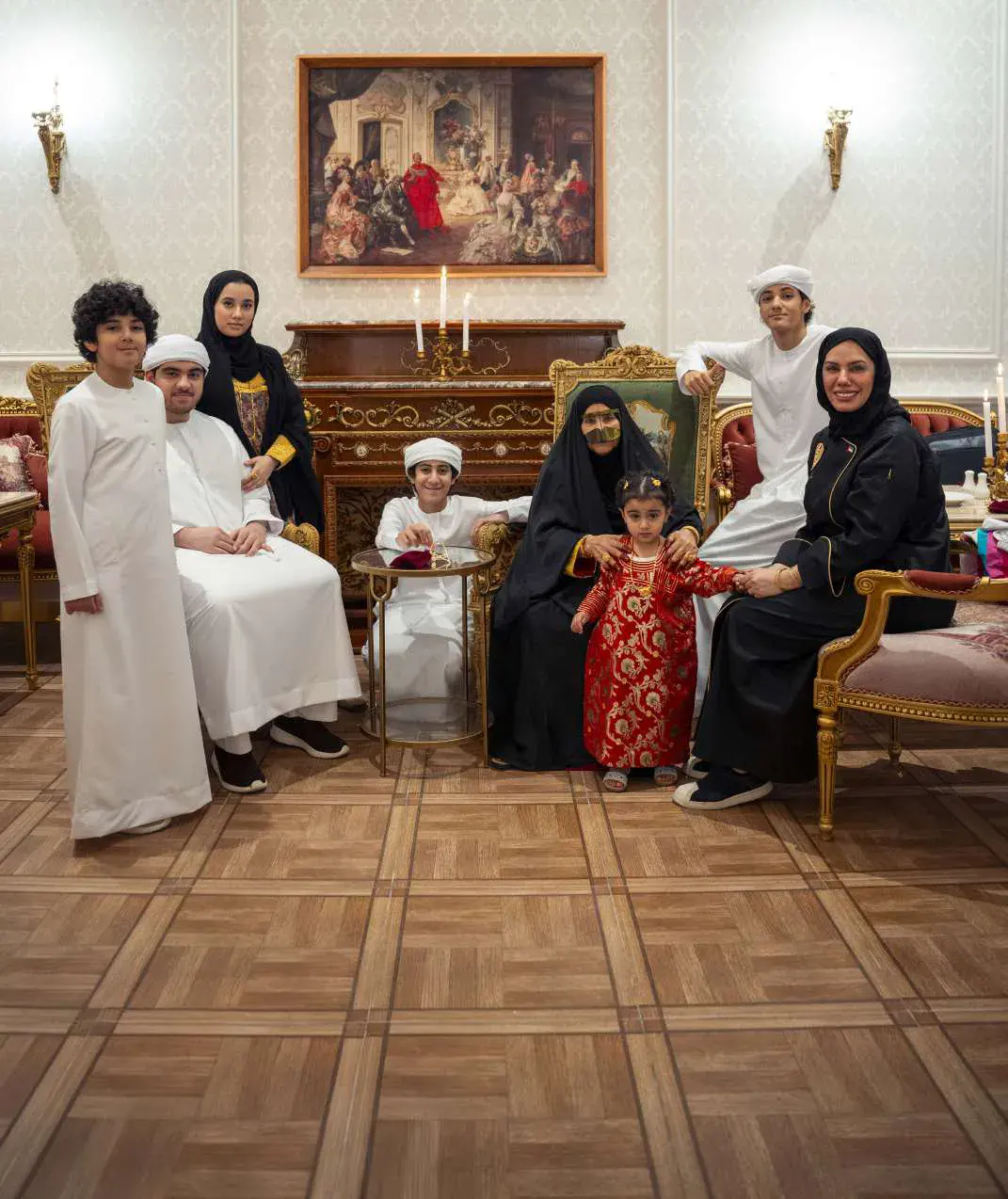 The family gathered in a majlis in traditional dress