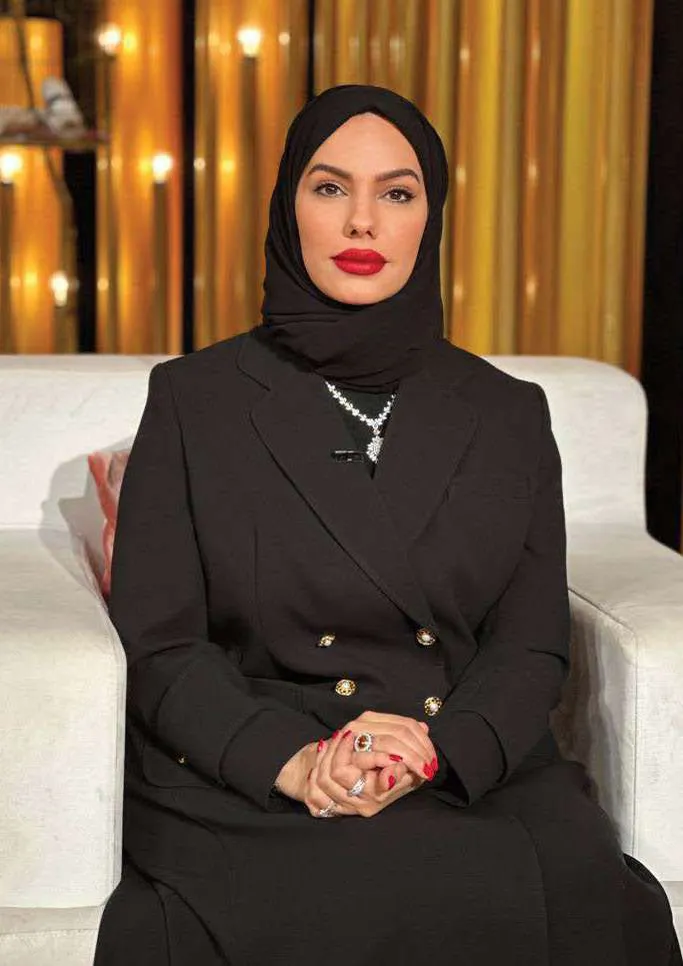 Chef Mariam, seated portrait in black