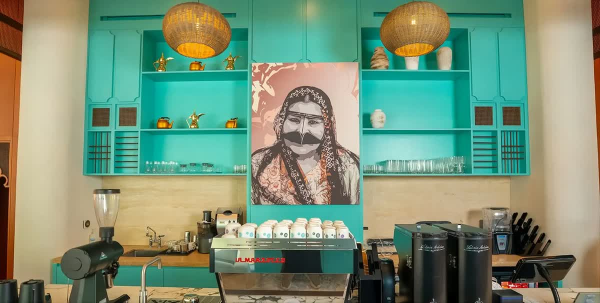 The Kashtat Amina room in turquoise with a portrait of Amina