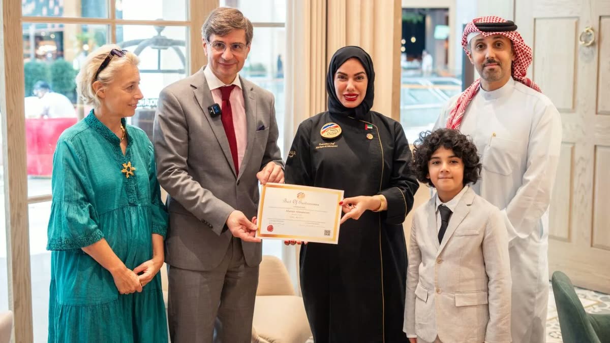 Chef Mariam Almansoori receiving an award alongside officials and family